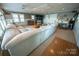 Spacious living room with large sofa, bar area, and multiple windows for natural light at 24264 Strand Dr, Albemarle, NC 28001