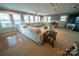 Bright living room featuring a large sectional sofa and multiple windows with blinds at 24264 Strand Dr, Albemarle, NC 28001