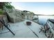 Outdoor patio with seating, a fire pit, steps to the lake, and stunning waterfront views at 24264 Strand Dr, Albemarle, NC 28001