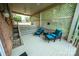 Comfortable patio space with latticework, furniture and stairs to upper level at 24264 Strand Dr, Albemarle, NC 28001