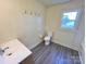 Bathroom featuring neutral walls, contrasting trim, and wood-look flooring at 2482 E Nc 10 Hwy, Conover, NC 28613