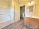 Bathroom featuring tub, neutral walls, wood-look flooring, and contrasting trim at 2482 E Nc 10 Hwy, Conover, NC 28613