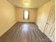 Cozy bedroom featuring neutral walls, contrasting trim, and wood-look flooring at 2482 E Nc 10 Hwy, Conover, NC 28613
