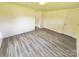 Bright bedroom featuring neutral walls, contrasting trim, and wood-look flooring at 2482 E Nc 10 Hwy, Conover, NC 28613