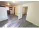 Open-concept living space featuring neutral walls, contrasting trim, and wood-look flooring at 2482 E Nc 10 Hwy, Conover, NC 28613