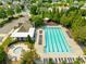 Aerial view featuring community pool with lounge chairs and picnic tables surrounded by green trees at 2802 Azalea Hills Dr, Charlotte, NC 28262