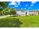 The house features a well maintained backyard with a lawn and mature trees at 2802 Azalea Hills Dr, Charlotte, NC 28262