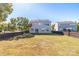 A spacious backyard with a lush green lawn and a wooden fence, offering ample space for outdoor enjoyment and relaxation at 2802 Azalea Hills Dr, Charlotte, NC 28262