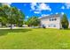 View of the home's backyard, featuring a lush lawn and trees at 2802 Azalea Hills Dr, Charlotte, NC 28262
