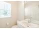 Cozy powder room with a white vanity, mirror, toilet, and a window offering natural light at 2802 Azalea Hills Dr, Charlotte, NC 28262