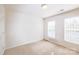 A neutrally decorated bedroom that includes two large windows for plenty of light at 2802 Azalea Hills Dr, Charlotte, NC 28262