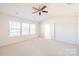 Large, bright bedroom with ample windows and double doors leading to ensuite bath at 2802 Azalea Hills Dr, Charlotte, NC 28262