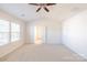 Large bedroom with neutral carpet, plenty of natural light, and double doors leading to the bathroom at 2802 Azalea Hills Dr, Charlotte, NC 28262