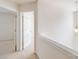 Hallway featuring carpet, white doors and trim with a hanging decorative light at 2802 Azalea Hills Dr, Charlotte, NC 28262