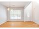 Bright and airy living room featuring wood floors, a large window, and neutral paint colors at 2802 Azalea Hills Dr, Charlotte, NC 28262