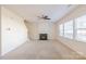 Spacious living room with fireplace, ceiling fan, and neutral carpet at 2802 Azalea Hills Dr, Charlotte, NC 28262