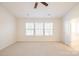 Spacious main bedroom featuring three windows, a ceiling fan and an ensuite bathroom at 2802 Azalea Hills Dr, Charlotte, NC 28262