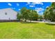 Lush green front yard with mature trees, enhancing the property's curb appeal at 2802 Azalea Hills Dr, Charlotte, NC 28262