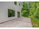 Home featuring a concrete patio and lush green backyard at 2908 Burgess Dr, Charlotte, NC 28208