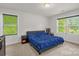 Comfortable bedroom with a plush bed and natural light from two large windows at 2908 Burgess Dr, Charlotte, NC 28208