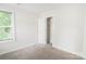 Bedroom with neutral walls, plush carpet, closet space and window views at 2908 Burgess Dr, Charlotte, NC 28208