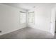 Bedroom with neutral walls, carpet, natural light from windows, and closet at 2908 Burgess Dr, Charlotte, NC 28208