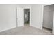 Bright bedroom with neutral carpet, white walls, and access to closet and additional room at 2908 Burgess Dr, Charlotte, NC 28208