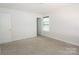 A bright bedroom with neutral walls, plush carpet, and natural light from a window at 2908 Burgess Dr, Charlotte, NC 28208