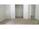 Spacious bedroom featuring plush carpeting, neutral walls, and a large closet with double doors at 2908 Burgess Dr, Charlotte, NC 28208