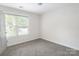 An open bedroom with neutral walls, plush carpet, and plenty of natural light at 2908 Burgess Dr, Charlotte, NC 28208