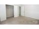 Bright bedroom featuring neutral walls, carpet, and closet space for easy organization at 2908 Burgess Dr, Charlotte, NC 28208