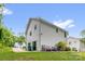 Two-story home with white siding and a back patio and green lawn, complemented by trees at 2908 Burgess Dr, Charlotte, NC 28208