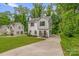 Beautiful two-story home featuring modern architecture, long driveway, and landscaped yard at 2908 Burgess Dr, Charlotte, NC 28208