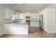 Well-lit kitchen boasts white cabinets, stainless steel appliances, granite countertops, and a breakfast bar at 2908 Burgess Dr, Charlotte, NC 28208