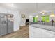 Open kitchen view showcasing the stainless steel refrigerator and seamless flow into the living area at 2908 Burgess Dr, Charlotte, NC 28208