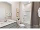 Clean bathroom features a modern sink, tile surround tub-shower, and neutral colored walls at 3019 Sassafras Trl, Gastonia, NC 28056