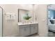 Bright bathroom with dual sinks, a large mirror, and neutral-colored cabinets at 3019 Sassafras Trl, Gastonia, NC 28056