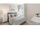 Comfortable bedroom features neutral walls, plush carpet, large window and modern night stand at 3019 Sassafras Trl, Gastonia, NC 28056