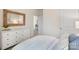 Bedroom features white walls, modern dresser, comfy bed and a view of the front yard at 3019 Sassafras Trl, Gastonia, NC 28056