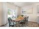 Bright dining room with a large table, modern chairs, and sliding glass doors leading to the backyard at 3019 Sassafras Trl, Gastonia, NC 28056