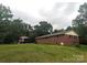 Well maintained yard with red brick home in the background and gazebo with seating at 3116 Pilgrim Rd, Chester, SC 29706