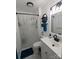 Bright bathroom featuring a shower with curtain, modern vanity, and decorative wall shelves at 3116 Pilgrim Rd, Chester, SC 29706
