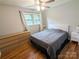 Neutral bedroom with wood floors, a large bed, dresser and windows for natural light at 3116 Pilgrim Rd, Chester, SC 29706