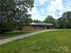 Charming brick home featuring an expansive front yard with mature trees and a covered carport at 3116 Pilgrim Rd, Chester, SC 29706