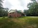 Brick home with a well-maintained lawn, surrounded by lush greenery and mature trees at 3116 Pilgrim Rd, Chester, SC 29706