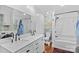 Bathroom features modern double sinks, bathtub with shower, attractive wallpaper, and newer washer/dryer at 314 Euclid Ave, Statesville, NC 28677