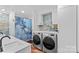 Bathroom features modern washer and dryer with granite countertops and attractive wallpaper at 314 Euclid Ave, Statesville, NC 28677