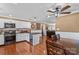 Open-concept kitchen featuring stainless appliances, an island with a cooler, and hardwood floors at 314 Euclid Ave, Statesville, NC 28677