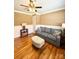 This living room features a gray couch, an ottoman, hardwood floors, and stylish side tables with lamps at 314 Euclid Ave, Statesville, NC 28677