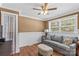 Bright and cozy living room featuring neutral color walls, hardwood floors, and a comfortable grey sofa at 314 Euclid Ave, Statesville, NC 28677